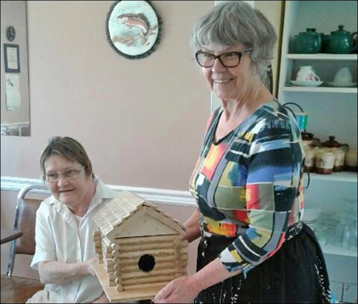 Norma Sherman presents Lorraine Scott and with the Rabbit Lake Library treat of the month prize of a handmade birdhouse. Photos by Alan Laughlin