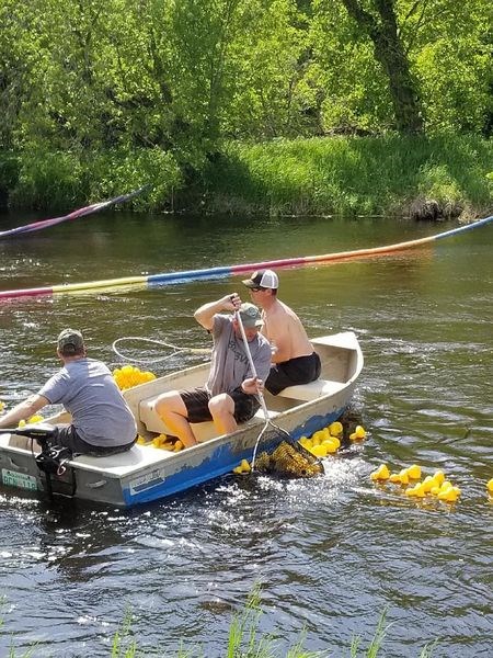 From left, Tyler Blender, Daniel Wasylenchuk and Craig Folk caught plastic ducks as they floated over the finish line during the Sturgis Kinsmen duck derby on June 10.