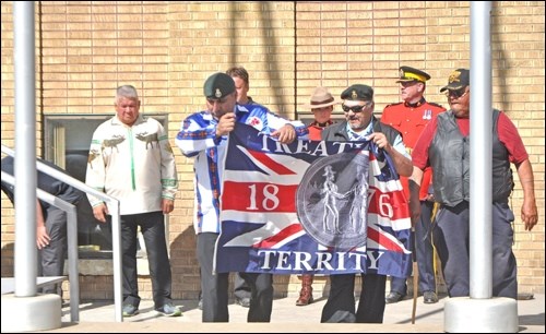 The Treaty 6 flag goes up permanently at City Hall on Thursday morning. Among those at the flag raising were Mayor Ryan Bater and Chief Wayne Semaganis of Little Pine First Nation. Photos by John Cairns