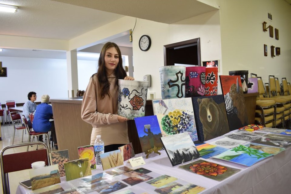 Holding one of her recent creations, “ice cream pail art” was young artist Alexis Koroluk, who enjoys working with multi-mediums.