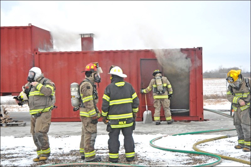 This was the scene at the fire department training facility near the airport on Thursday, as firefighters took part in flashover training at their new flashover simulator. The unit arrived last Tuesday and went straight to work on Thursday afternoon. Photos by John Cairns