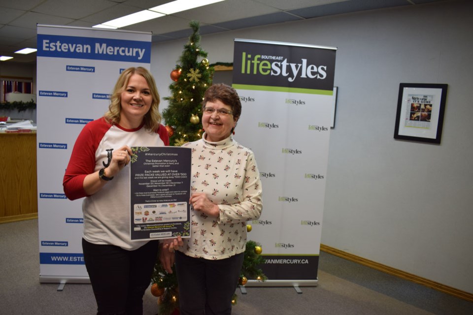 Estevan Mercury Publications sales manager Deanna Tarnes, left, congratulates Audrey Garrioch on winning the grand prize in the #MercuryChristmas promotion.