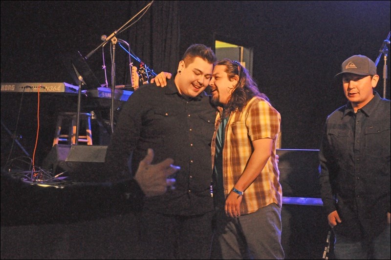 Runner up Aaron Arcand shares a moment with top male vocalist Kiefer Paul (left).