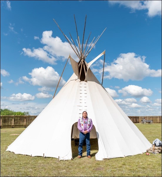 Alvin Baptiste stands in front of one of the tipis he erected for Indigenous People Day at Fort Battleford.