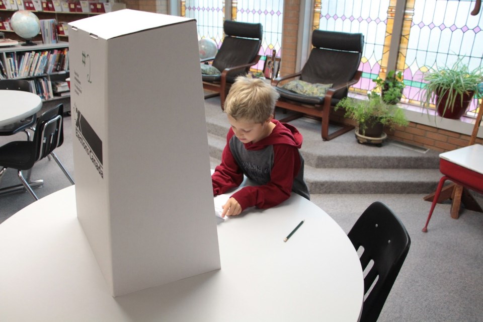 Exley Fish marks his ballot.