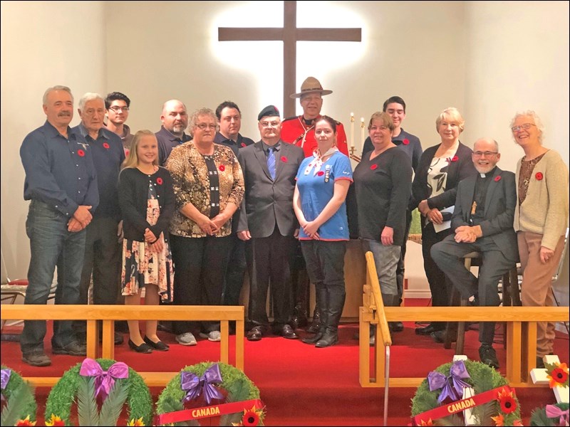 Participating in the Radisson Remembrance Day service were: front row - Bruce Flath, Darby Wererzak, Leona Bennett, Murray Mikituk, Jade Baker, Robyn Baker, Rev Sheldon Carr, Gertrude Maxwell; back row - Erwin Hamp, James Armistad, James Usselman, Nathan Halischuk, Cst. Gary Pepin, Judah Tyreman and Tina Hessell. Photo submitted by Lorraine Olinyk