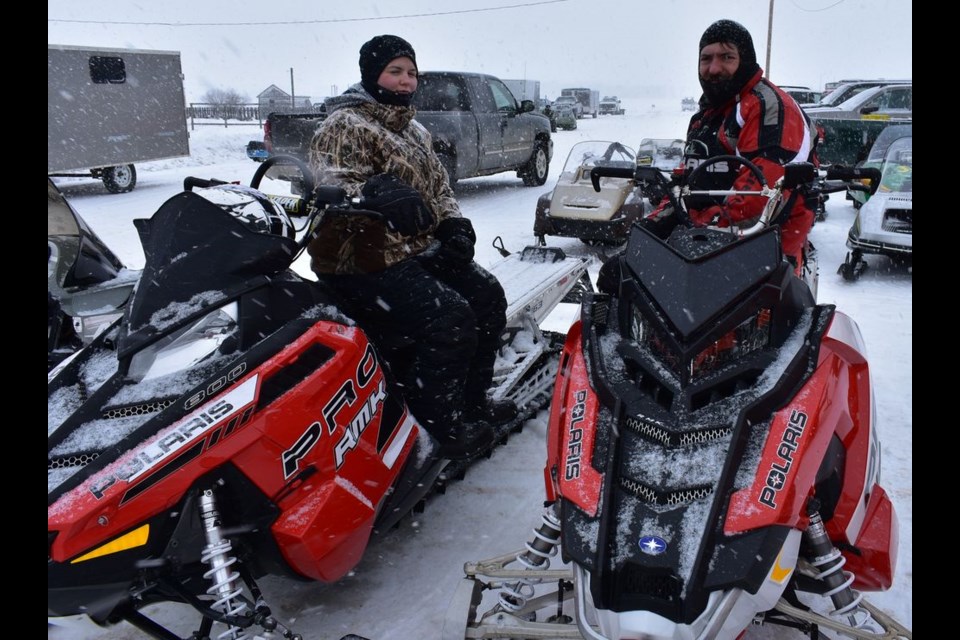 Linda Konowalchuk, left, and Jeff Airriess were ready to participate in the Togo snowmobile derby on February 16 despite the falling snow and brisk wind.