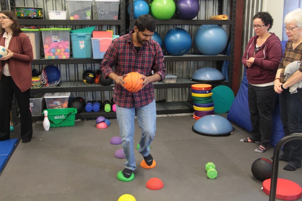 Subramani Arumugam, Sensory Gym Facilitator, demonstrates an activity at the Sensory Gym.