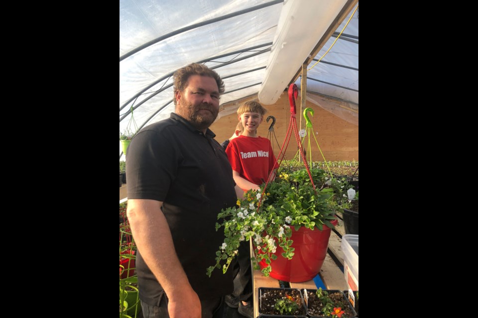 Gerald and Kwade Murphy at the Tail-Ling Hills Farm Greenhouse. Photo submitted