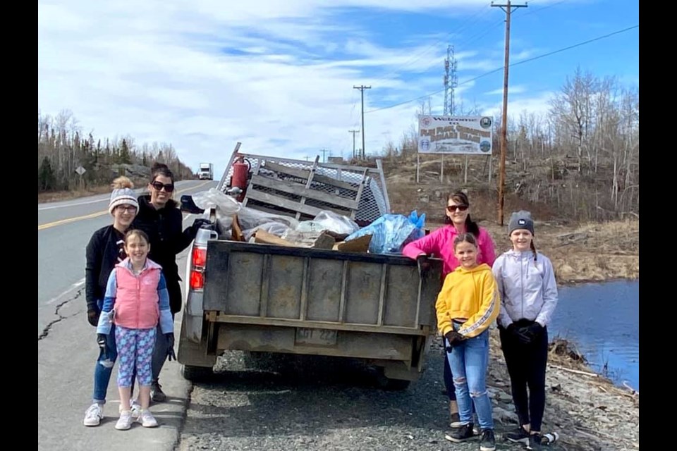 Members of the Keramydas and Alexander families pick up litter along Highway 10 as part of Mother's Day for Mother Earth. - SUBMITTED PHOTO