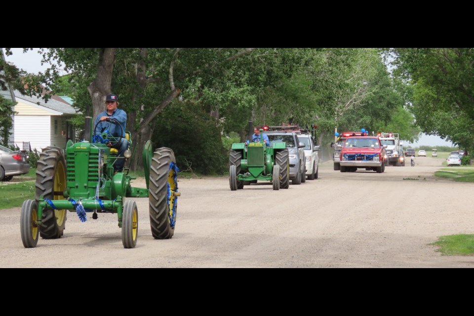 The grad parade procession makes its way down the streets of Dinsmore.