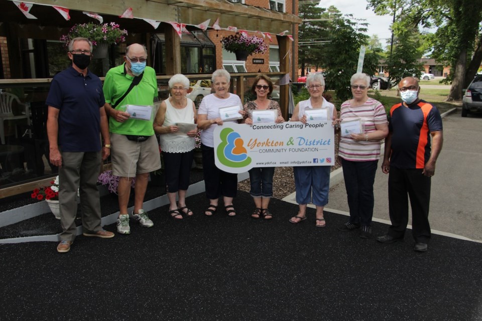 Larry Pearen and Vic Surjik (left) and Samuel Tim (right) with the Yorkton and District Community Foundation presented masks to residents at Independent Manor.