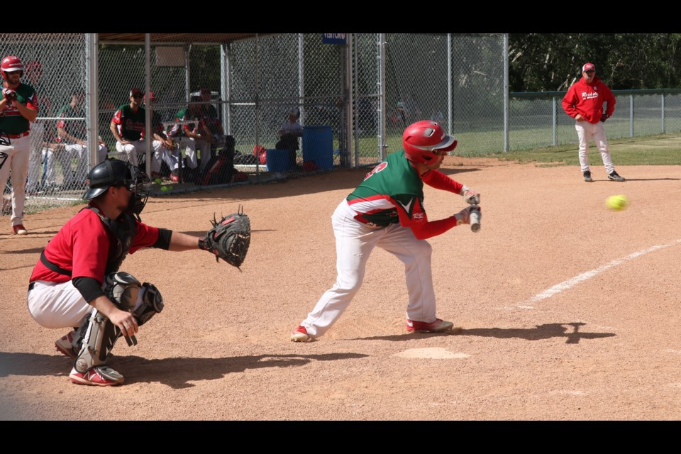 Rocket batter Jason Smalley squares to bunt.