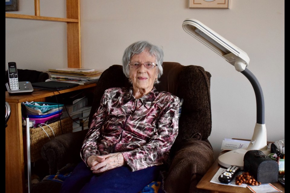 Marie Dubreuil, pictured sitting in her chair where she does her daily embroidery.