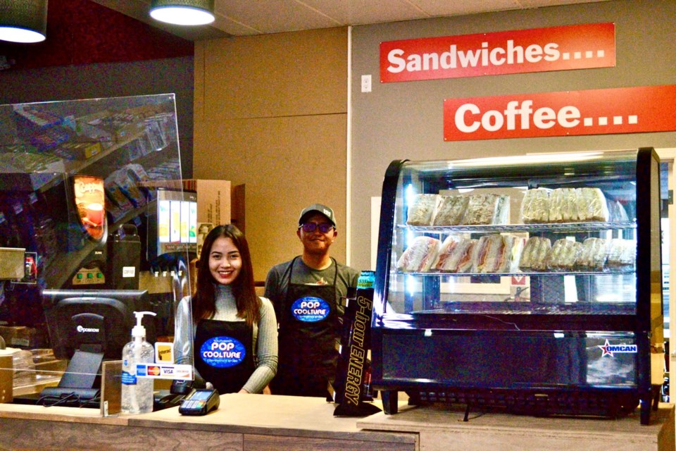 Nyze Cretecio, left, helps Orvil Mahinay with the new convenience store/coffee shop in downtown Estevan. Photo by Anastasiia Bykhovskaia