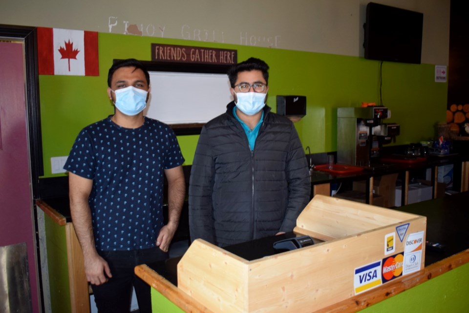 From left, Bhaumik Chaudhari, left, and Sachin Chaudhari look forward to seeing customers at Pinocchio Pizza.