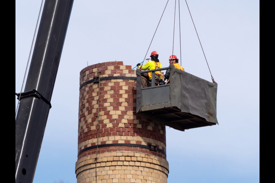 According to Dan Sankey, building manager for the Ministry of SaskBuilds and Procurement, the work on dismantling the smokestack at the former SHNB is under way. The first priority is to remove the decorative brick at the top of the chimney so it can be preserved.