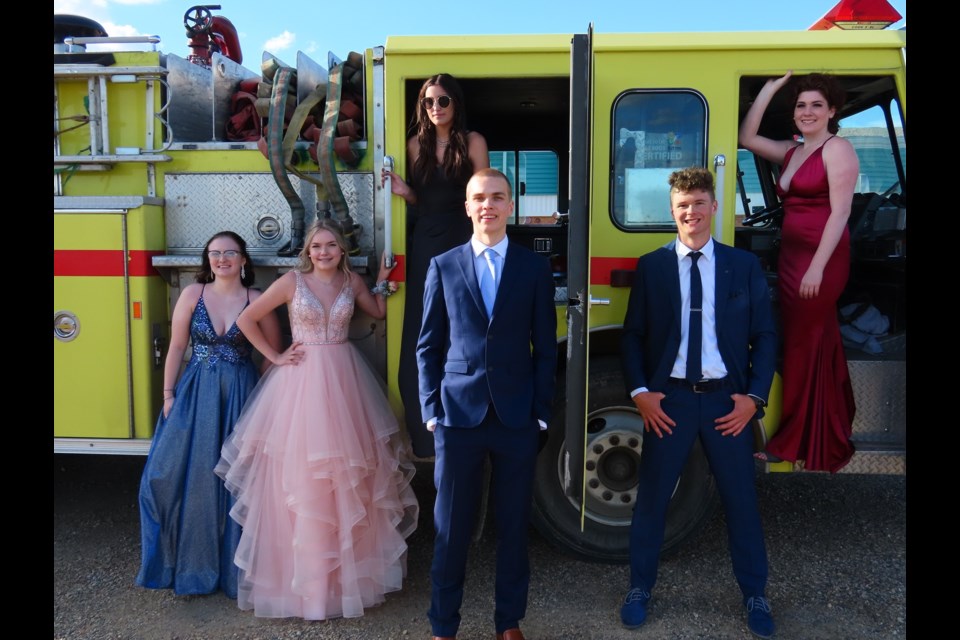 The Loreburn Central School Class of 2021: Kayla Zacharias, Kaitlyn Hovland, Emmitt Hundeby, and Brennan Graham in front, while standing in the truck are Rhian Dorward and Jessica Sabraw.