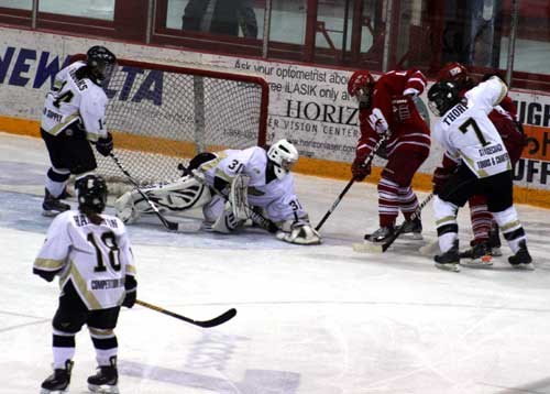 Weyburn Gold Wings goalie Jane Kish holds on to the puck as a Notre Dame player tries to poke the puck away from her, during the Gold Wings' season home opening game on Oct. 4 at Crescent Point Place. Players Hailey Brooks, No. 14, Meagan Hamilton, No. 18 and Whitney Thorp, No. 7, watch the action around their net in second period action. The Gold Wings edged out the Hounds by the score of 2-1 to start the season on a positive note.