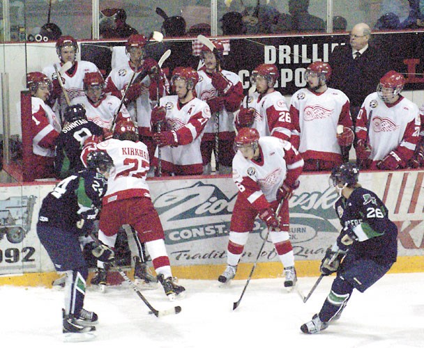 A Kindersley Klipper gets pushed into the Weyburn Red Wing's players box by Blake Kirkham (No. 27) during playoff action at Crescent Point Place on Wednesday night. In front, Kevin Mann (No. 6) keeps an eye on the puck as he battles for possession with two Klippers. The Red Wings stayed alive in the Sherwood semi-final against the Klippers by winning 4-1 in game four of the best-of-seven series.