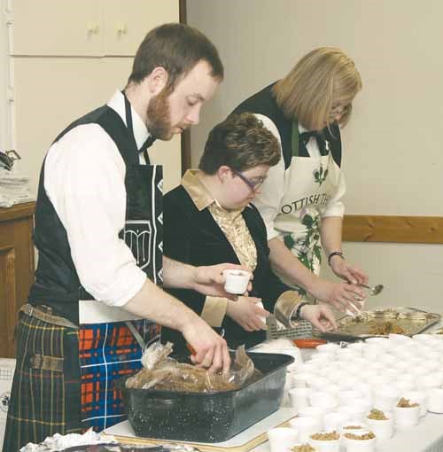 Jordan Craib-Petkau, Jennifer Gillard and Sheila MacDonald (L-R) serve out helpings of haggis.