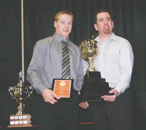 Chase Norrish (left) won his second major award at the banquet. Norrish was named the Most Valuable Defenceman for the Terriers. Presenting the award to Norrish is Casey O'Brien , Terriers assistant coach..