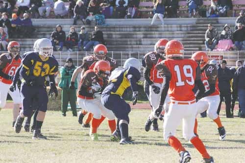 Zach Fleury (14, centre) rips the ball out of the hands of the Renegade running back. Fleury would go on to score a defensive touchdown on the play.