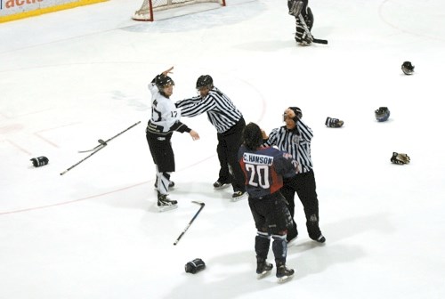 Tony Oak and Cody Hanson are separated by the linesmen during a mini line brawl in the third period, a the ice was littered with gloves, helmets and sticks.