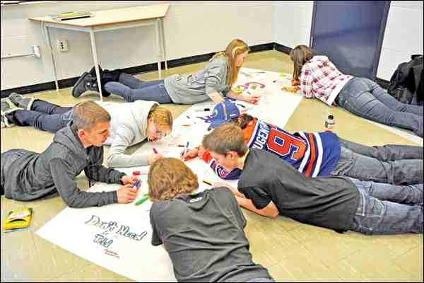 Students taking part in hands-on activity as part of a Feb. 28 presentation at North Battleford Comprehensive High School.