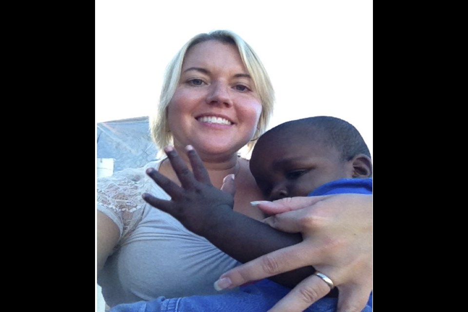 Chelsea Grande with a Haitian orphan. It is estimated there are 30,000 children in institutions throughout Haiti, out of which as many as 80 per cent may not be orphans in an official sense, but have only one parent.