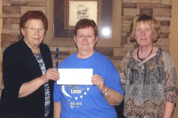 Madeline Phaneuf, president of Harwood Manor, presents a cheque to Dawne Tokaryk of the Canadian Cancer Sociity. At right is Donna Van Dyke, recreation director of Harwood Manor.