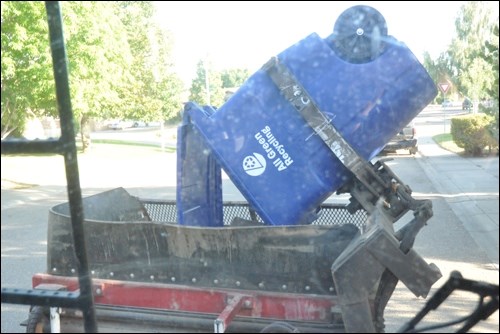 A look at the "claw" in action as it grabs a blue cart and empties the recyclables into the Curotto-Can.