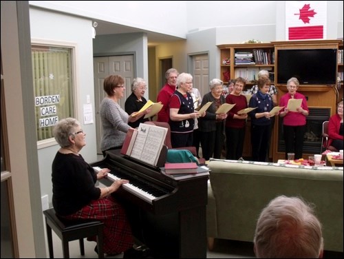 Jackie Meister at piano and the ladies from Radisson Lutheran Church singing carols at the Borden Care Home Tea Dec. 5.