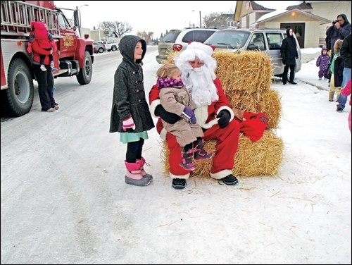 Santa Claus at Radisson Dec. 13 handing out candy bags to the children.