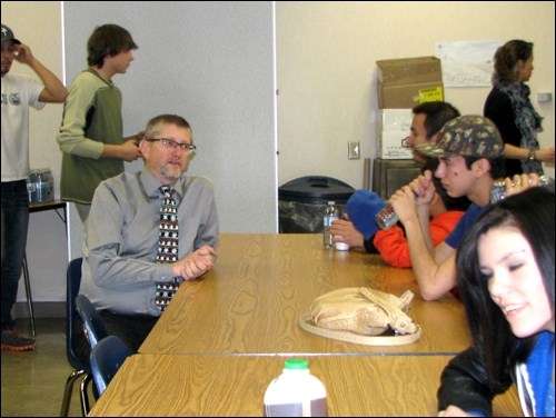 Principal Carlo Hansen talks with students at a pre-Christmas turkey supper hosted by the Braided Journeys Program at John Paul II Collegiate