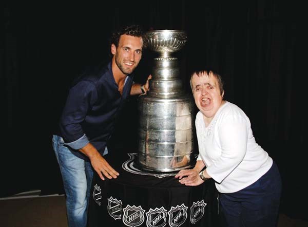 Donna Moore, a huge sports fan, celebrated the Los Angeles King’s 2012 Stanley Cup victory with Jarret Stoll.