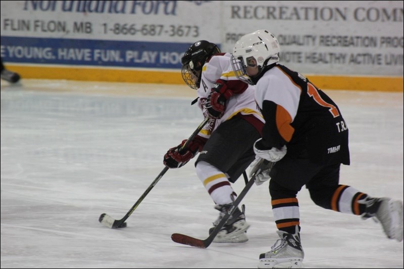 Atom A Northland Ford Bomber Jake Kuzmiak tries to break away from a Thompson Miner during the round-robin play of the Jason Morran Memorial Tournament this past weekend.