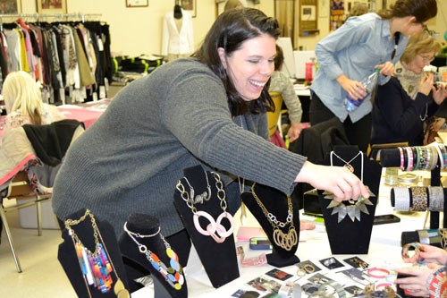 Vendor Christina Birch of Carlyle not only organized Carlyle's first winter market, she was a vendor, too. Here, Birch serves a customer purchasing a piece of  'Color By Amber' jewellery. Birch debuted items from the company's spring line at the winter market, and says the items for men, women, and children are “Ethically-produced and directly benefit the people in developing countries who help make the products.”