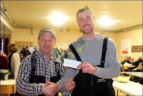 Ag. Association president Russell Aumack presents a cheque for $2,500 to Randy Tiringer.