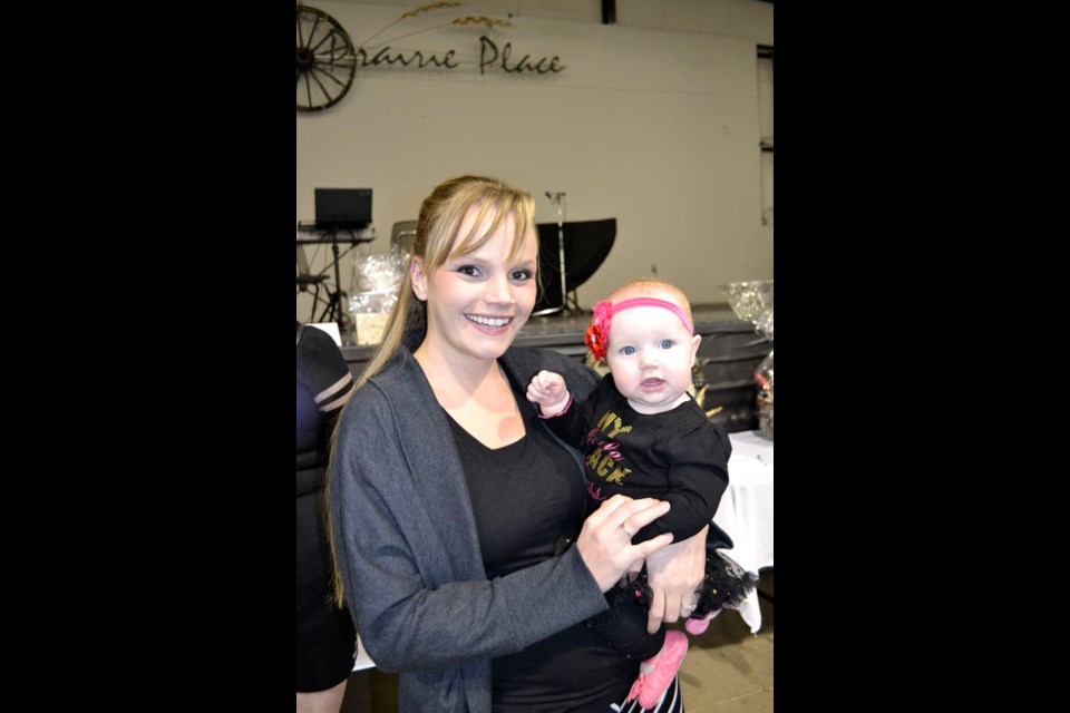 Women of all ages got their glam on at Arcola Daycare's 'Little Black Dress Event.' Pictured is one of the youngest attendees-wearing the tiniest of little black dresses-eight-month-old Rylee Brady, with her mom, Dawn Brady.