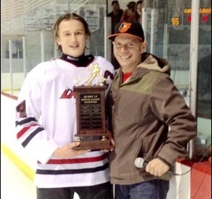 The Unity Bantam Red team captured the Highway 14 League championship title at home defeating Biggar Nationals in game three of the series. Carter Acton, team captain, accepts the league championship trophy from Unity Minor Hockey president Dan Feser.