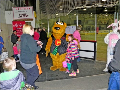 Easter egg hunt participants enjoying a visit with Co-op mascot Cooper.