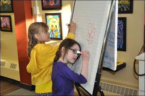 “Children creating art is what I love,” says artist Leah Marie Dorian. These young artists engaged in some artwork during a recent reception for the donation of Dorian’s art to the Allen Sapp Gallery.