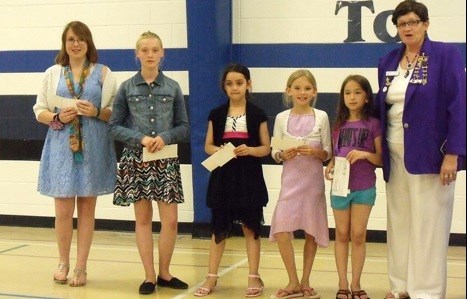 Lorraine Olinyk of Radisson Royal purple presenting Saskatchewan Elks Foundation cheques to Borden students Sarah Sleidricht, Jade Matte, Felicity Fisher, Julia Siebert and Julia Hebig.