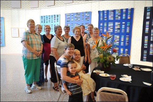 Fellow quilters presented Heather Hochbaum with a bouquet of flowers at an artist's reception Thursday, Aug. 13.