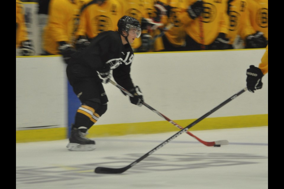 Team Black forward Braden Oleksyn attempts to enter the opposition zone during the third period of the Bruins annual Gerry Aspen Cup Sunday at Affinity Place.