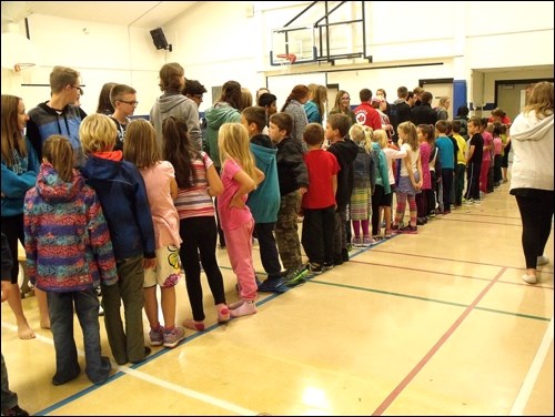 Borden Grade 1 -6 buddying up with Grades 7 -12 to do a Terry Fox run Sept. 30. Photos by Lorraine Olinyk