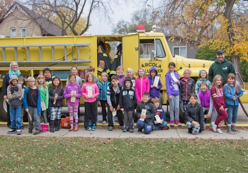 The Arcola grade 3/4 class thoroughly enjoyed themselves as local volunteer firefighters showed them around their fire truck for Fire Prevention Week.