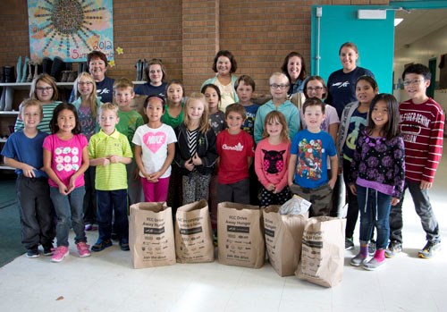 Students from Carlyle Elementary School join Farm Credit Canada employees who weighed a total of 283.4 lbs raised by the students.