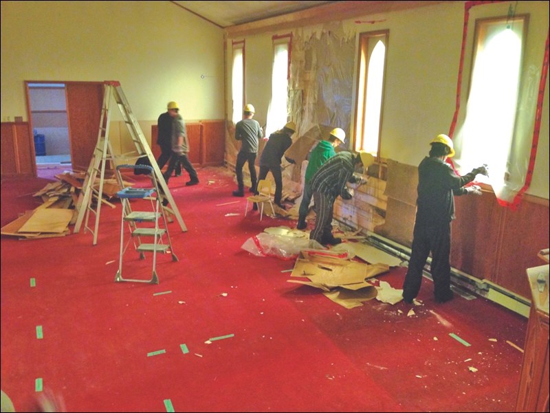 Students from the Trades Applied Carpentry class work on the former St. Andrew’s Presbyterian Church, transforming it into a home.